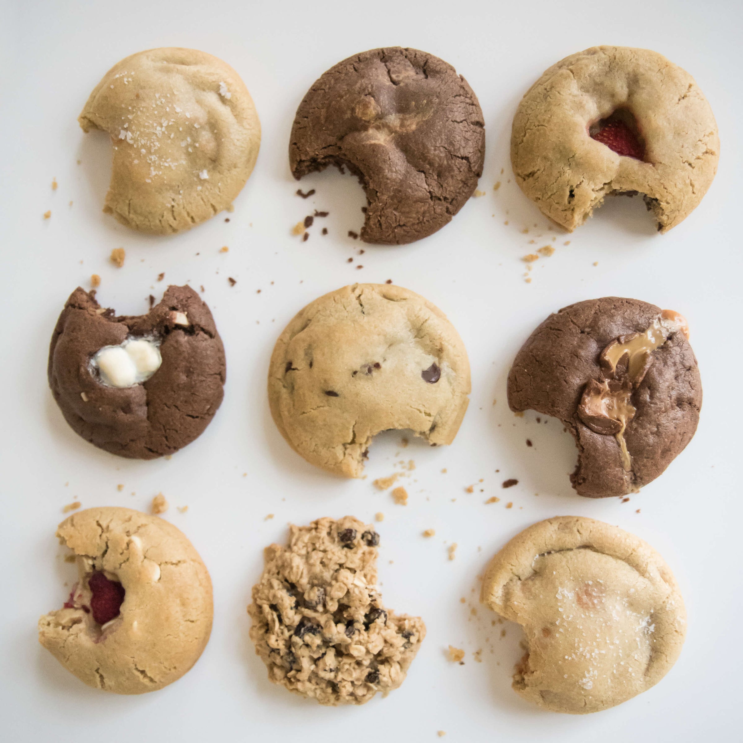 Multiple cookies, with a bite taken out of each one, arranged in a 3x3 grid.